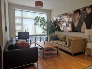 a living room with a couch and a table at Lovely London on a budget! in London
