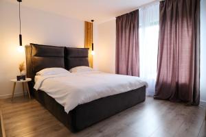 a bedroom with a large bed and a large window at RDT Guest House-Rai din Transilvania in Moieciu de Jos