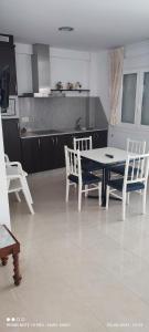 a kitchen with a table and chairs in a room at Hotel Brisa del Mar in O Grove