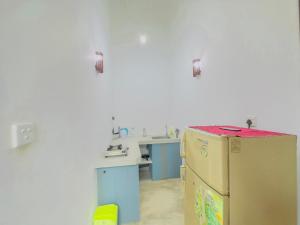 a kitchen with a refrigerator and a sink in it at Sayuru Villa in Hikkaduwa