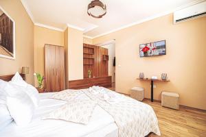 Postel nebo postele na pokoji v ubytování Forum Hotel