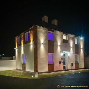 a brick building with purple windows at night at #2 TGHA Luxury Studio Apartment in Athlone in Athlone