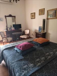 a bedroom with a bed with pillows and a piano at B&B Maddalena Di San Zeno in Verona