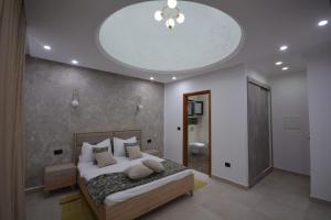 a bedroom with a bed and a ceiling at Diar Nader in Midoun
