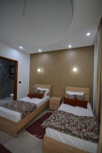 a room with two beds in a room at Diar Nader in Midoun