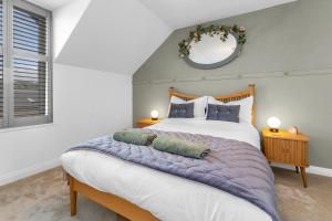 a bedroom with a large bed and a mirror at Beeswing, a Victorian Gem in Biggar in Biggar