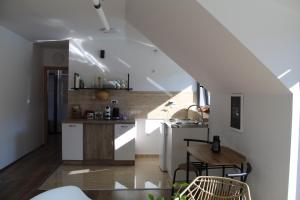 a kitchen with white cabinets and a wooden table at Infinity in Novi Sad