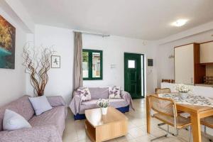 a living room with a couch and a table at DISI 5A in Ayía Paraskeví