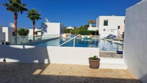 a swimming pool with a potted plant next to a building at DISI 5A in Ayía Paraskeví