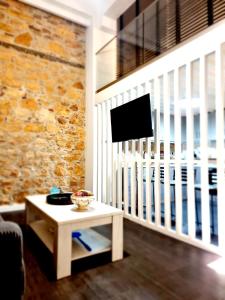 a living room with a table and a tv at Castle luxury home in Chios