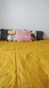 - une couette jaune sur un lit dans la chambre dans l'établissement HABITACION COMODA, à Guadalajara