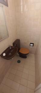 a bathroom with a toilet and a sink at Apartamento Ubatuba Vista para o Mar in Ubatuba +84 photos