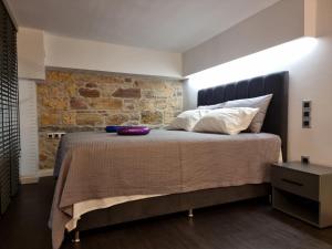 a bedroom with a large bed with a brick wall at Castle luxury home in Chios
