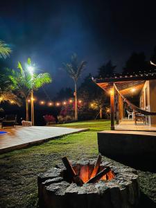 a fire pit in front of a house at night at Sítio por do Sol - Pedra Azul - ES in Pedra Azul