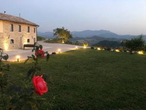 a view of a house with a green yard at B&B Il Passo in Urbino