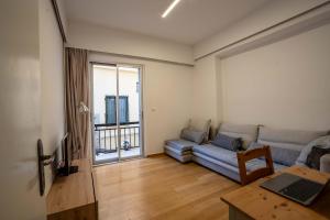 a living room with a couch and a table at Lefkas Town Apartment in Lefkada Town