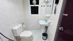 a small bathroom with a toilet and a sink at Royal Prince Hotel in Dubai