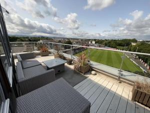 a balcony with chairs and a field of grass at The Kilmainham Spire View Apartment in Dublin