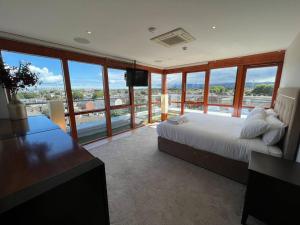 a bedroom with a bed and a view of the ocean at The Kilmainham Spire View Apartment in Dublin