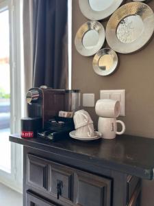 a counter with a coffee maker and plates and mirrors at Boutique Centrale in Brione sopra Minusio