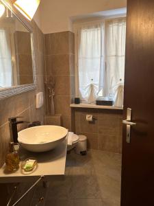 a bathroom with a white sink and a toilet at Boutique Centrale in Brione sopra Minusio