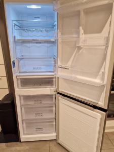 an empty refrigerator with its door open and its contents at Modern two bedroom house 