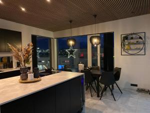 a kitchen and dining room with a table and chairs at Luxury villa with gym and sauna in Reykjavík