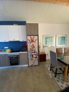 a kitchen with a table and a refrigerator in a room at Casa das Mouriscas in Casal da Igreja +75 photos