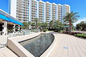 a swimming pool in front of a large building at Beautiful Junior 2BR/2BA Palms Resort in Destin in Destin