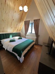 a bedroom with a large bed in a attic at A-Frame 7 CRESTE in Borşa