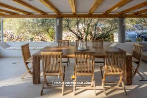 drewniany stół i krzesła na patio w obiekcie Villa 5 elements w mieście Gostinjac
