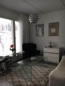 a living room with a glass table and a couch at Poukamankatu 14 As, 1 in Kuopio