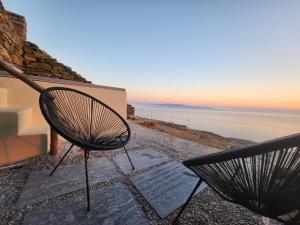 a couple of chairs sitting on top of a house at Sunflower Tinos House in Istérnia