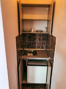 a small kitchen with a counter and a sink at Peaceful, Cosy Tivat Guesthouse in Tivat