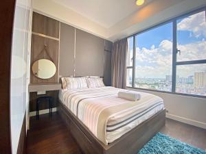 a bedroom with a large bed with a large window at YO's Homes Rivergate Apartment Infinity Pool Near District 1 in Ho Chi Minh City +119 photos