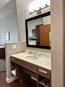 a bathroom with a sink and a mirror at Best Western PLUS Peppertree Inn at Omak in Omak