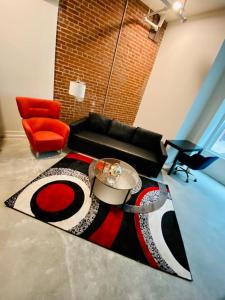 a living room with a couch and a rug at Downtown Near Busch Stadium/Convention Center in Saint Louis