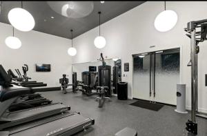 a gym with treadmills and machines in a room at Downtown Near Busch Stadium/Convention Center in Saint Louis