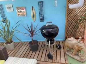 a bbq grill on a wooden floor with plants at Casa Vista Maroma in Málaga