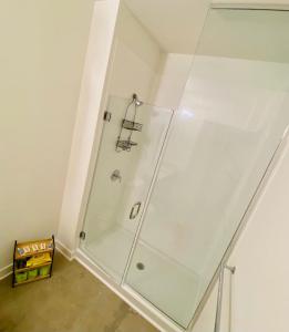 a shower with a glass door in a bathroom at Downtown Near Busch Stadium/Convention Center in Saint Louis