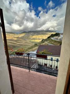 a room with a balcony with a view of a valley at Villa Tardioli in Castelluccio