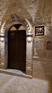 an entrance to a building with a wooden door at Iris apartments in Monopoli