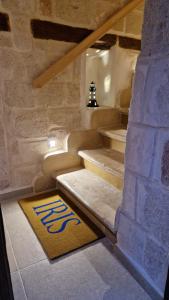 a set of stairs with a rug on the floor at Iris apartments in Monopoli