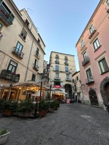 a street with two tall buildings in a city at Bed And Salerno - Largo Campo - Appartamento in Salerno