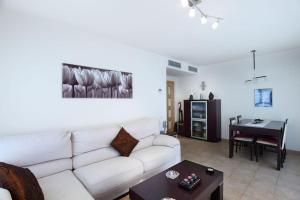 een woonkamer met een witte bank en een tafel bij RESIDENTIAL FLAT Lloret de Mar (Nex in Lloret de Mar