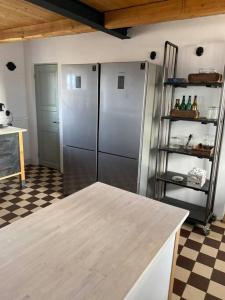 cocina con nevera de acero inoxidable y suelo a cuadros en 10 min från Malmö/Lund en Staffanstorp