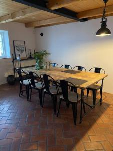 a large wooden table and chairs in a room at 10 min från Malmö/Lund in Staffanstorp