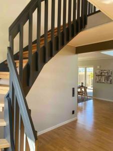 a staircase in a living room with a wooden floor at 10 min från Malmö/Lund in Staffanstorp