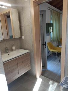 a bathroom with a sink and a mirror at Studio Marianna in Oziás +55 photos