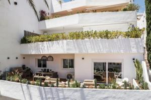 un edificio blanco con plantas a su lado en Super Stylish Apartment in Fantastic Location, en Marbella
